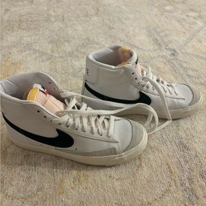 Women’s size 8 high top, black and white Nike sneakers. Worn once.